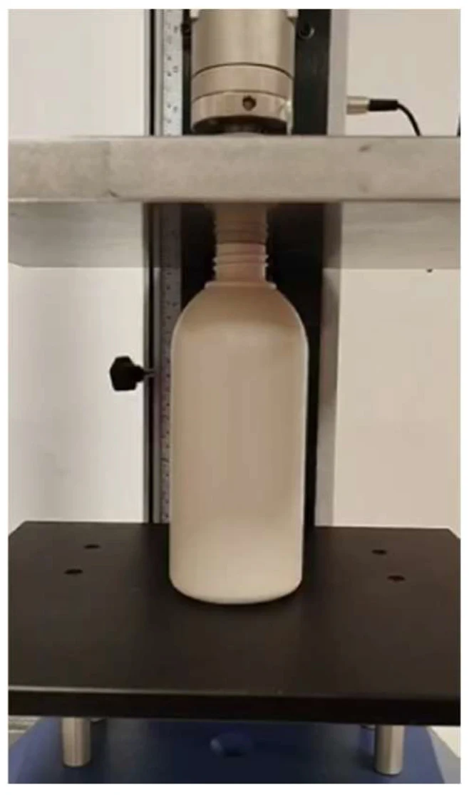 A bottle prototype between compression-test platens